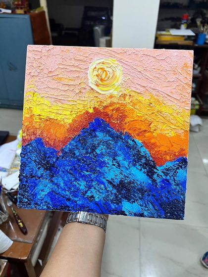 Another fantastic landscape from our kids' palette knife class, showing a vibrant sun and textured mountains.