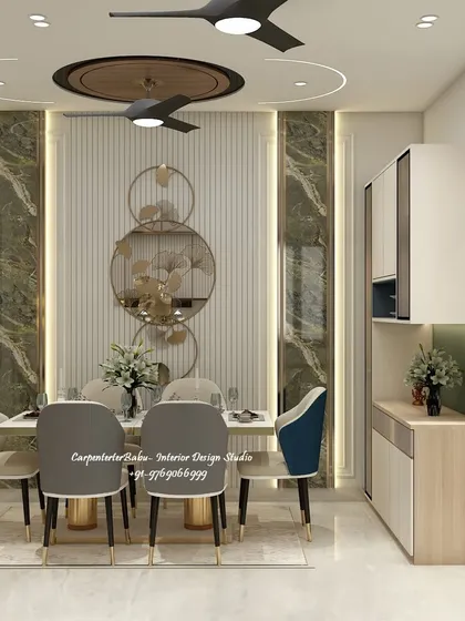 This dining area features a stunning marble-paneled wall with circular metal art. The dark green and blue chairs add a touch of jewel-toned elegance.
