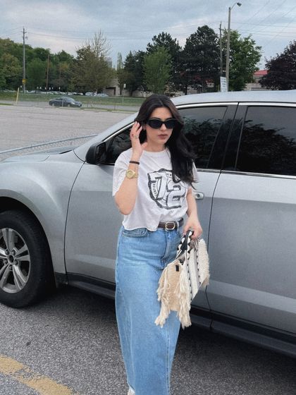 A full-length shot of the shopping outfit next to a car, a common lifestyle setting.