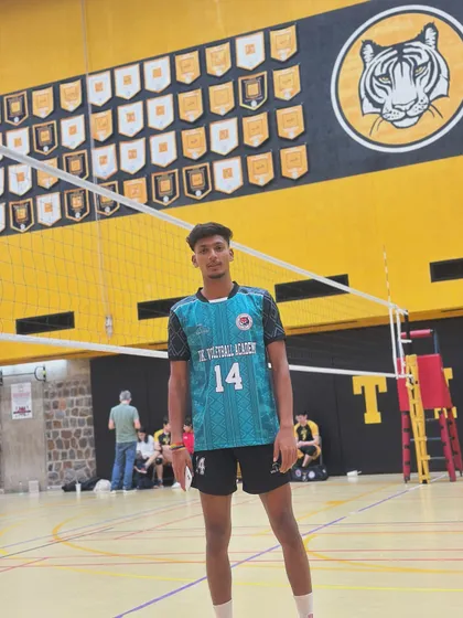 A player from our academy standing on an indoor court, ready for the match. We prepare our athletes for both outdoor sand and indoor hardcourt competitions.