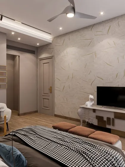 The TV wall in this bedroom is designed with textured wallpaper and a minimalist console with gold accents. The houndstooth throw on the bed adds a classic touch to the modern design.