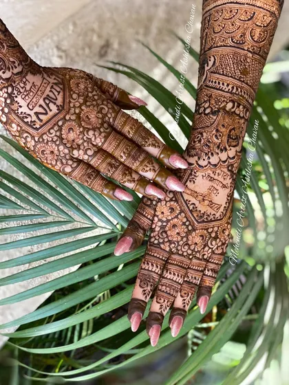 A close up of a bridal back hand design, showing the intricate details and the inclusion of the groom's name.