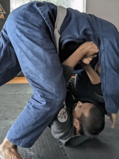An action shot from a Gi Jiu Jitsu session. The art is addictive, and we offer classes every day for those who want to join the obsession.
