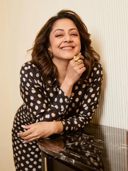 Jyotika looking cheerful and stylish in a black and white polka dot dress, with bright green heels adding a fun pop of color.