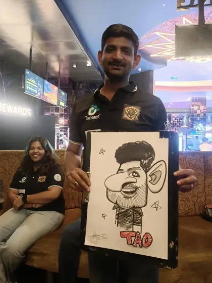 An employee from TAO Architects enjoying his caricature. These events are great for team morale.