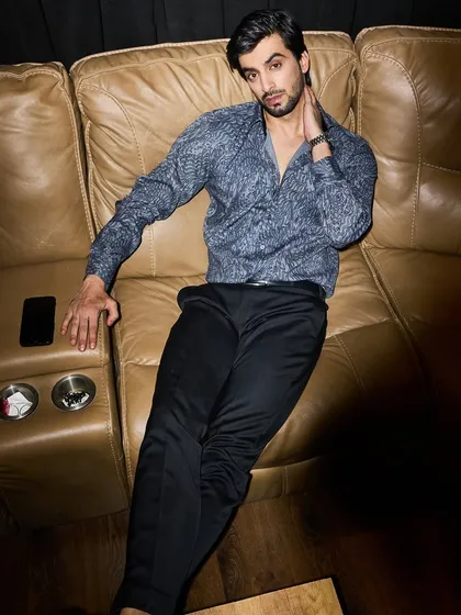 My party wear is designed for the man who is the star of the evening. This printed designer shirt, paired with classic black trousers, offers a look that is confident and relaxed. It's the right combination of glitz and fashion for a cocktail night or a friend's birthday.