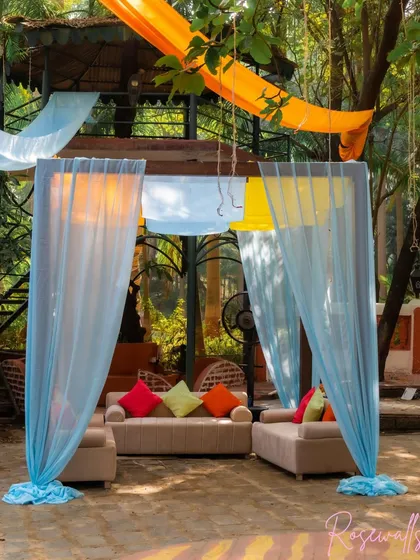 A view of one of our draped cabanas, creating a semi-private and comfortable lounge space for guests amidst the carnival celebration.