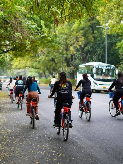 A group of women riders enjoys a tour under a canopy of trees. Our rides are a great way to connect with nature right in the heart of the city.