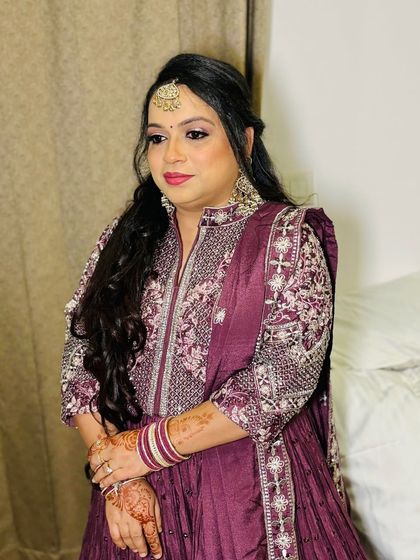 An elegant party look in a deep purple anarkali.