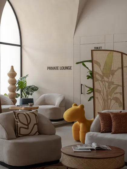 A detail shot showing the designated private lounge, pantry, and toilet areas, cleverly integrated into the design with a stylish rattan screen.