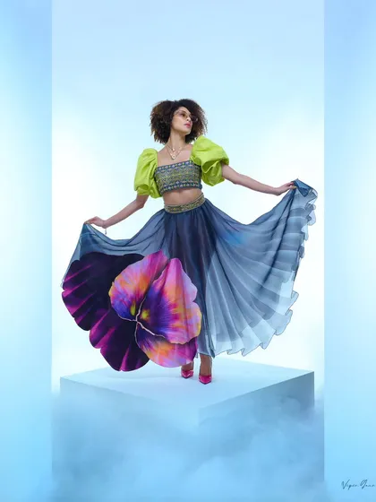 This shot from a designer campaign captures the energy and artistry I bring to fashion photography. The focus is on creating a dynamic mood that makes the garment feel alive, using dramatic posing and controlled studio lighting to highlight the flow and unique design of the skirt.