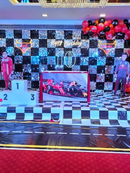 This Formula 1 racing theme was a huge hit, featuring a checkered sequin backdrop, a winner's podium, and custom cutouts. I love bringing high energy themes like this to life for birthdays.