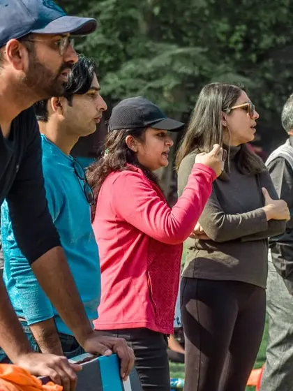Parents and spectators watch a finals match with intense focus from the sidelines.