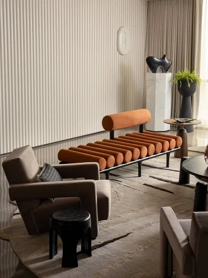This living area from a Parisian-inspired home showcases my passion for curating unique pieces. The space combines a fluted feature wall, sculptural furniture, and contemporary art to create a layered and eclectic look that is both artistic and comfortable.