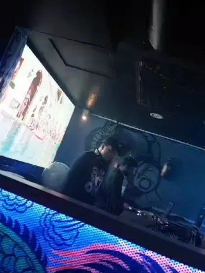 My setup includes a full audio-visual experience. While I'm mixing the tracks, I'm also VJing, running the official music videos and custom visuals on the big screens to create a complete sensory experience.