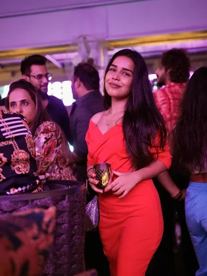 A guest looking radiant and enjoying the party atmosphere.