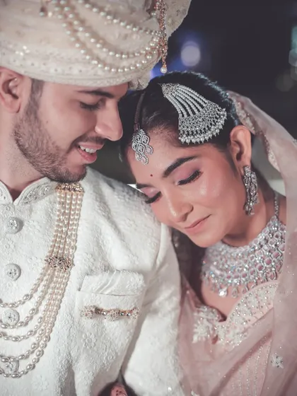 A tender close-up of the couple, with the bride resting her head on the groom's shoulder.