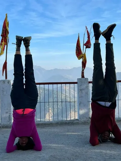 A partner headstand in Rishikesh. Working with a partner can help you safely explore and build confidence in advanced inversions.