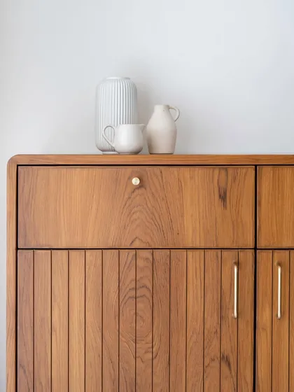 A closer look at our 'Marshall' collection. This multipurpose crockery unit showcases the line's signature style with its fluted shutters, gently curved edges, and elegant brass knobs, blending retro charm with clean, modern lines.