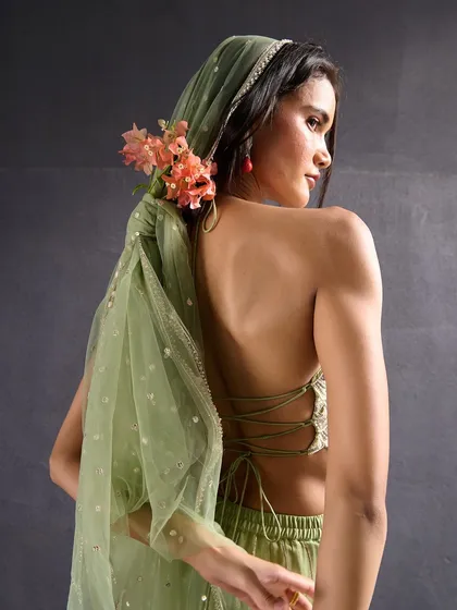 The back of this mint green halter top features a delicate tie-up design, adding a touch of modern sensuality to the traditional look.