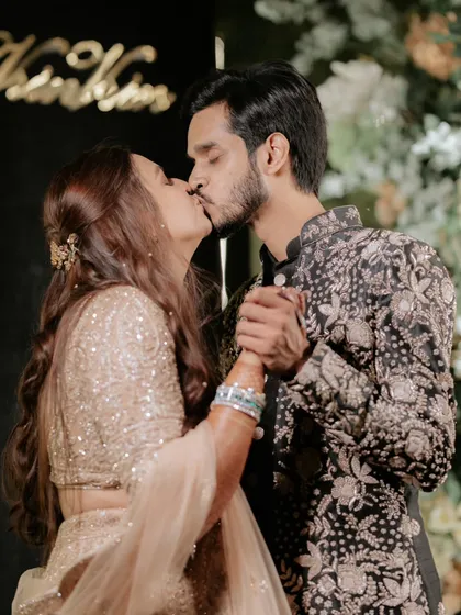 A kiss that seals the promise. This intimate moment between Karan and Vrinda at their engagement party captures the culmination of a love story that began at a Coldplay concert.
