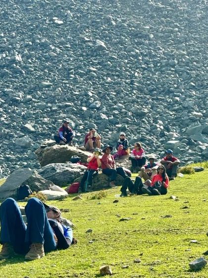 Taking a well-deserved rest amidst the vast, rocky landscape. These pauses are just as important as the hiking, allowing us to soak in the grandeur of the Himalayas.