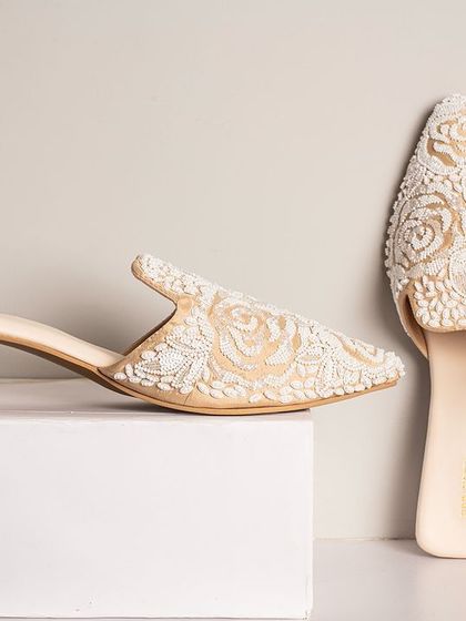 These elegant mules by Urbansway are all about subtle beauty and a little shimmer. The intricate white floral embroidery on a neutral base makes them a versatile and stylish choice for both festive and casual-chic outfits.