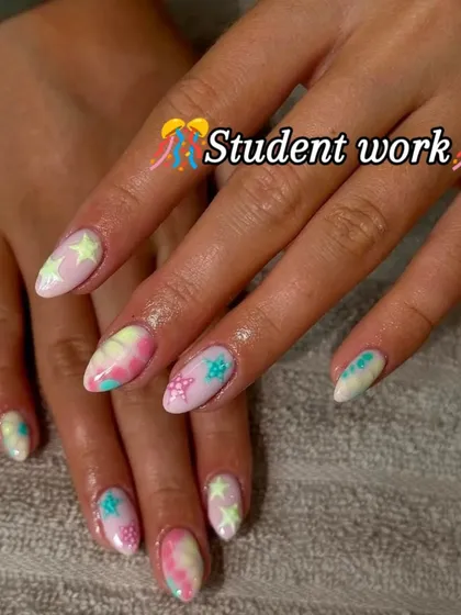 A student's creative take on pastel tie-dye nails with star accents. My classes encourage you to experiment with trends and develop your unique artistic style.