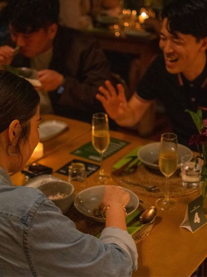 Guests sharing a laugh over dinner during The Second House, Goa pop-up. Our space is designed to foster community and connection.