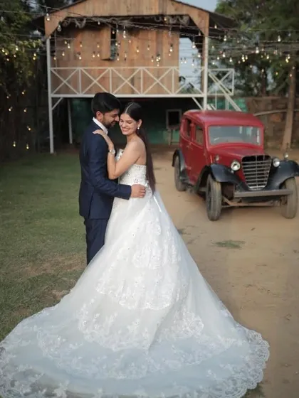 For a timeless and classic pre-wedding shoot, our white lace ball gown is a perfect choice. This gown features intricate detailing and a full skirt with a train, offering a sophisticated bridal look that pairs beautifully with vintage or rustic settings.