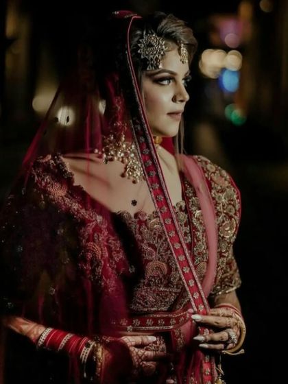 A dramatic and moody bridal portrait. The makeup is crafted to look stunning even in low light, with defined features that create a powerful and timeless image.