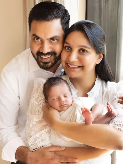 Sometimes the most beautiful moments happen right at home. This lifestyle family portrait captures the natural, relaxed love of a new family in their own comfortable space.