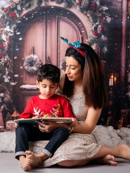 Reading a Christmas story in a magical, snowy setting. These themed setups transport families to a winter wonderland, right in my Mumbai studio.