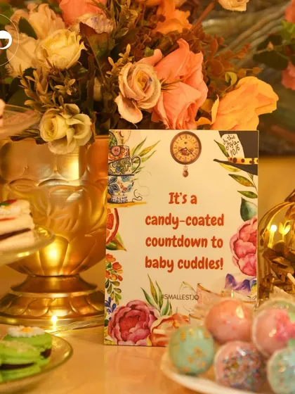 A candy-coated countdown sign on a dessert table filled with macarons and cake pops, creating a sweet and whimsical display.