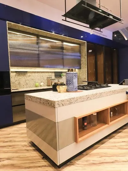 Another angle of our blue showroom kitchen, highlighting the integrated appliances and the beautiful granite island countertop.