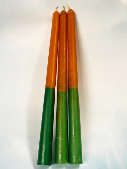 These are our Road Opener Taper Candles, made in auspicious green and orange colors. They are designed to help clear obstacles from your path.