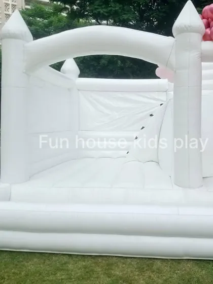 A close-up of the entrance to our white bounce castle, showing the spacious jumping area inside.