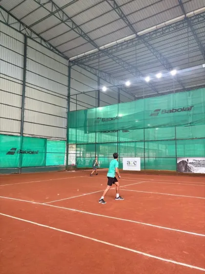 A doubles match in progress on the clay courts in Ahmedabad. Our players learn to adapt to different surfaces.
