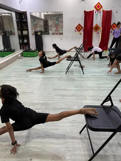 Another angle of our students working on their flexibility, highlighting their focus and determination.