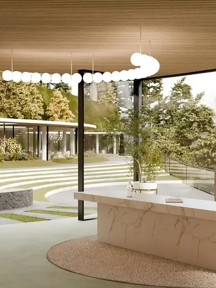 The reception area of the resort, with a marble desk and an open-air design that looks out onto the terraced landscape and fire pit.