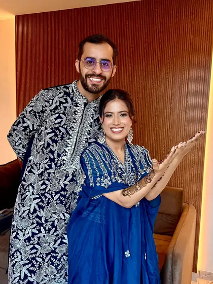 A happy couple at their Mehendi. Her makeup is fresh and natural, perfect for a fun, relaxed celebration.