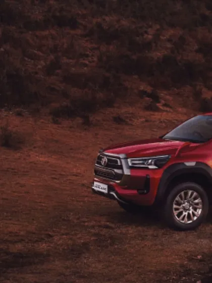 A mood shot of the Toyota Hilux in a rugged, natural environment, setting the stage for an adventure-themed campaign where the vehicle is the hero.
