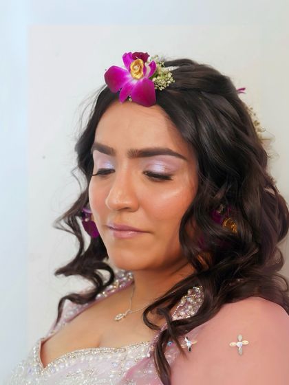 A close-up of the bride's Haldi makeup. With her eyes closed, you can see the soft wash of pastel eyeshadow, a perfect choice for a fun and festive daytime event.