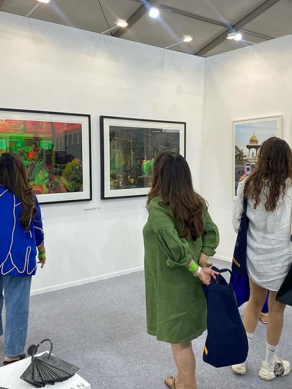 A group of women admiring the photography section of our booth.