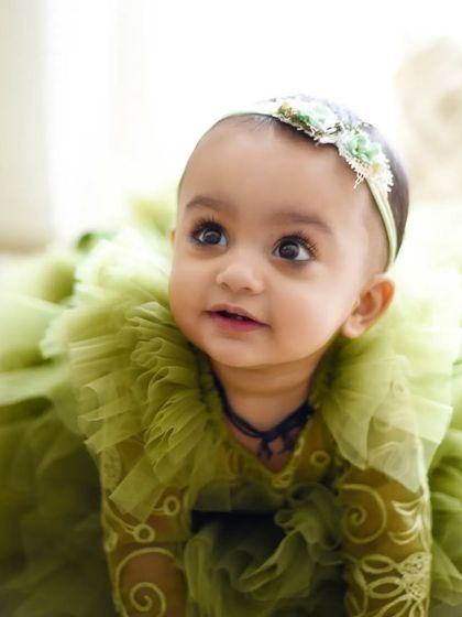 Capturing babies on the move. This little one, celebrating her first birthday, looks up with curiosity. The soft, natural light makes her eyes sparkle.