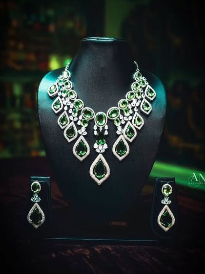 This emerald green and diamond-look necklace is a statement piece, perfect for a cocktail party or reception.