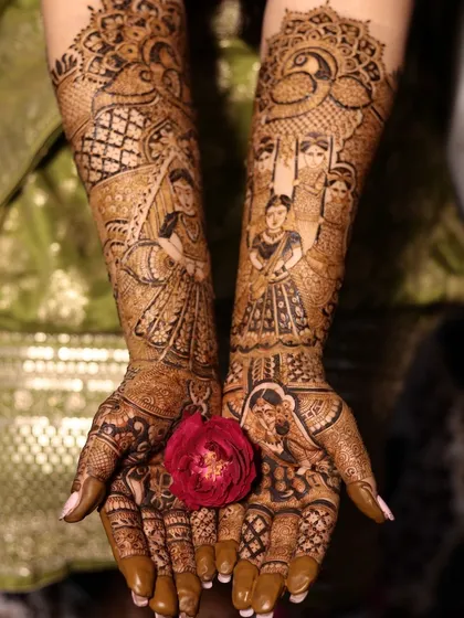 A stunning full-coverage bridal mehndi with portraits of the bride, her family, and other traditional figures, all held together with intricate geometric and floral patterns.