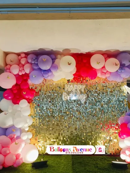 A full view of the sequin wall party setup, showing the beautiful contrast between the sparkling backdrop and the colorful balloons.