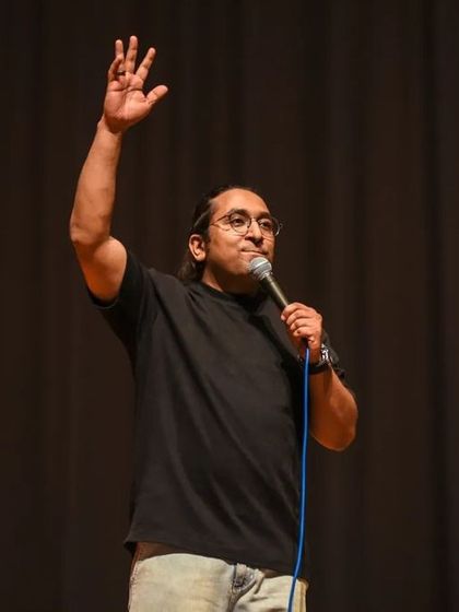 Appurv Gupta waving to the cheering crowd at BITS Hyderabad after a successful comedy night.