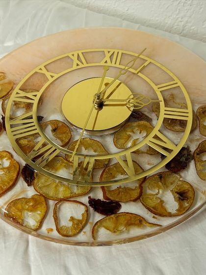 Another angle of the orange and strawberry slice clock. The combination of colors and textures makes this a truly unique and eye-catching piece of home decor.